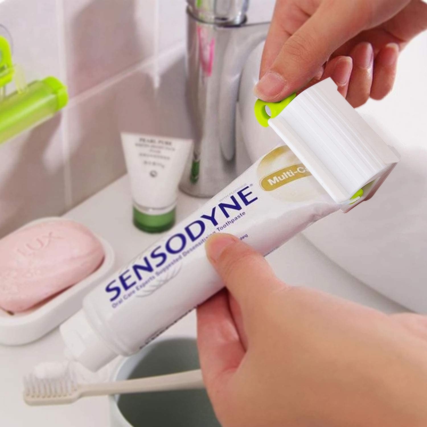 person using the squeezer on a tube of toothpaste
