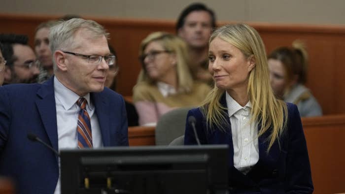 Actor Gwyneth Paltrow looks at her attorney and smiles in a courtroom