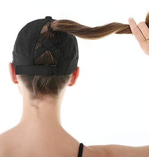 a person showing their ponytail going through the back of the cap