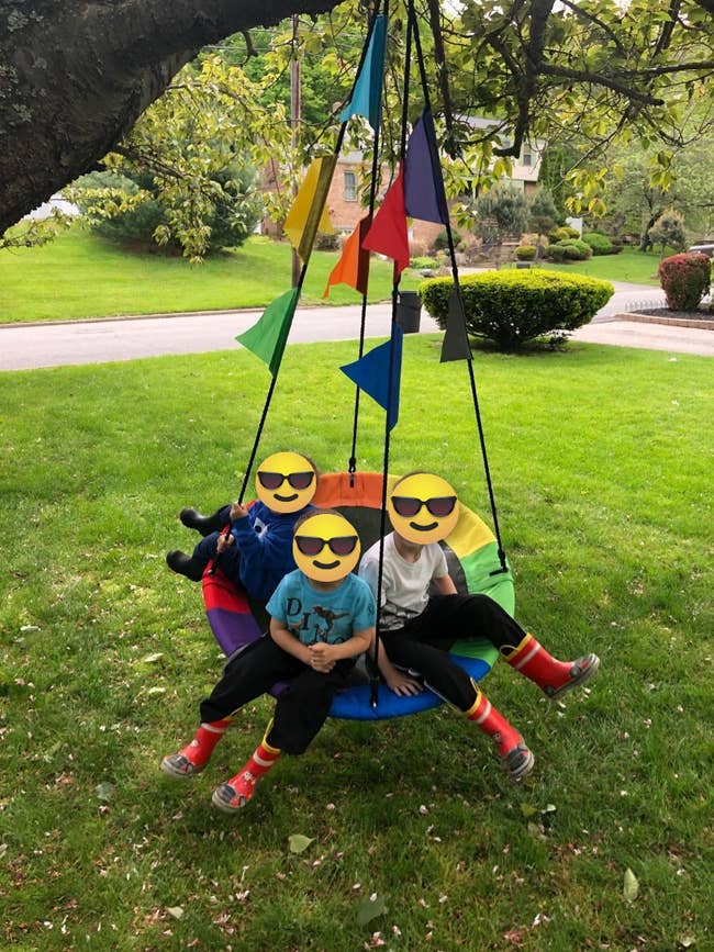 reviewer image of three kids swinging on the saucer swing