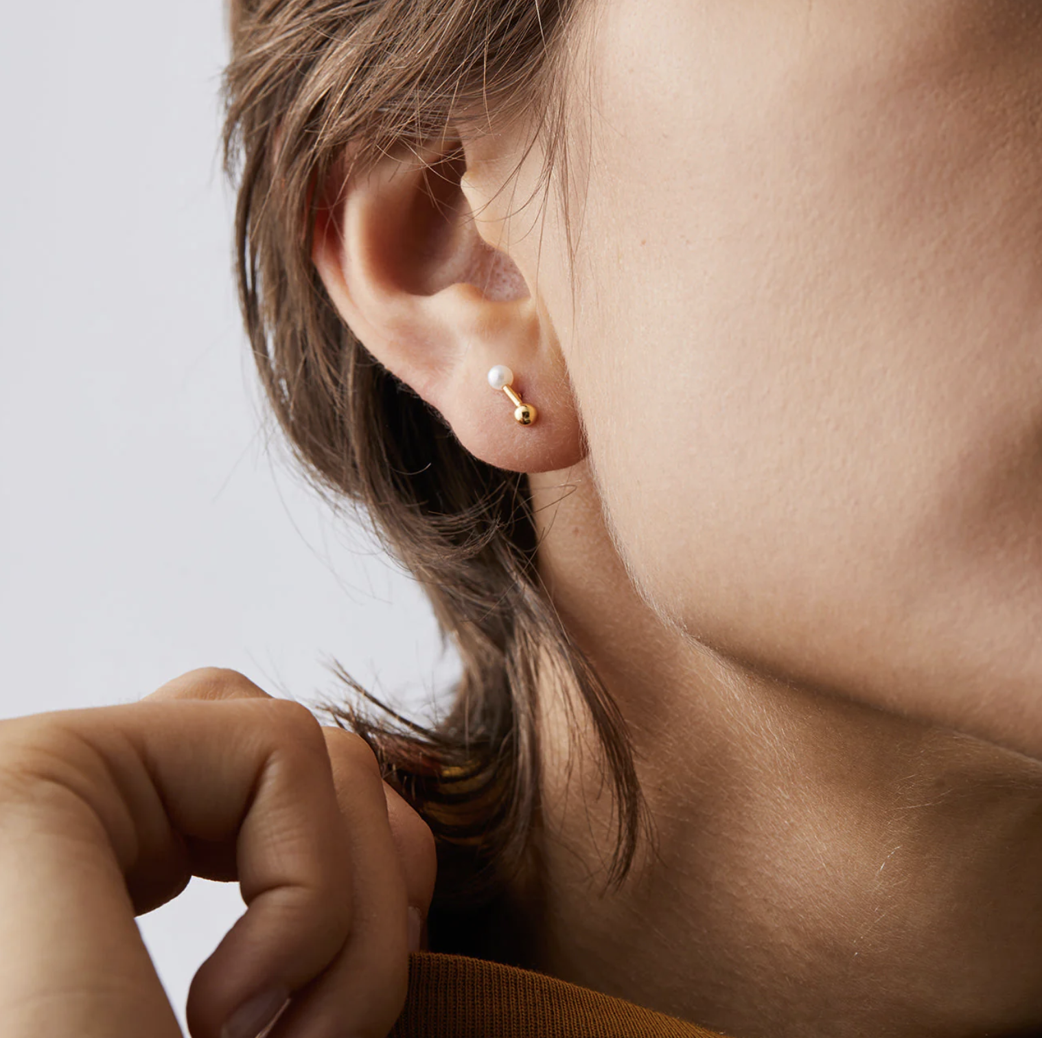A person wearing one of the studs in their ear