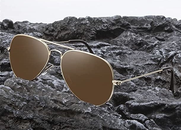 a pair of sunglasses resting on a rock