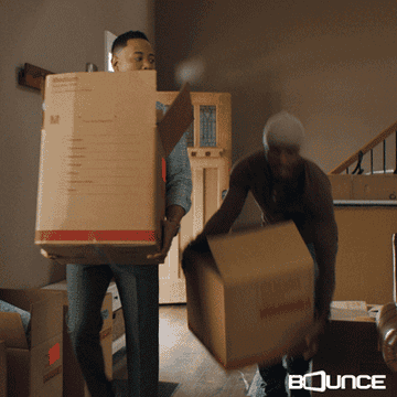 two people with moving boxes