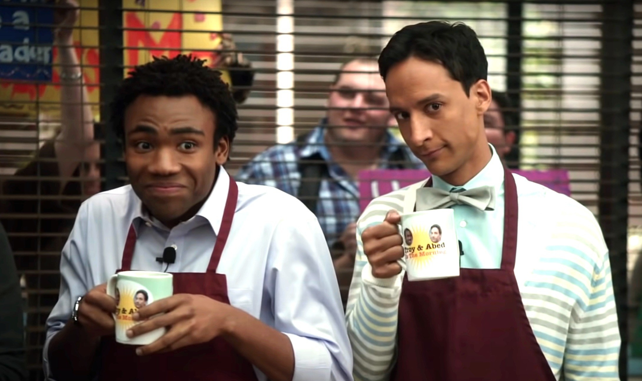 troy and abed holding up mugs with their faces