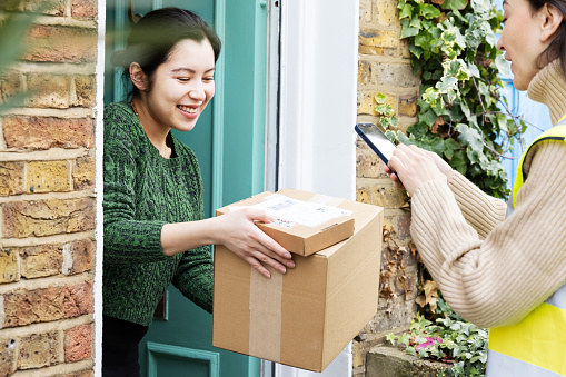 a person accepting packages at their door