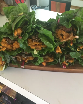 swiss chard wrapped around various burrito ingredients instead of a tortilla