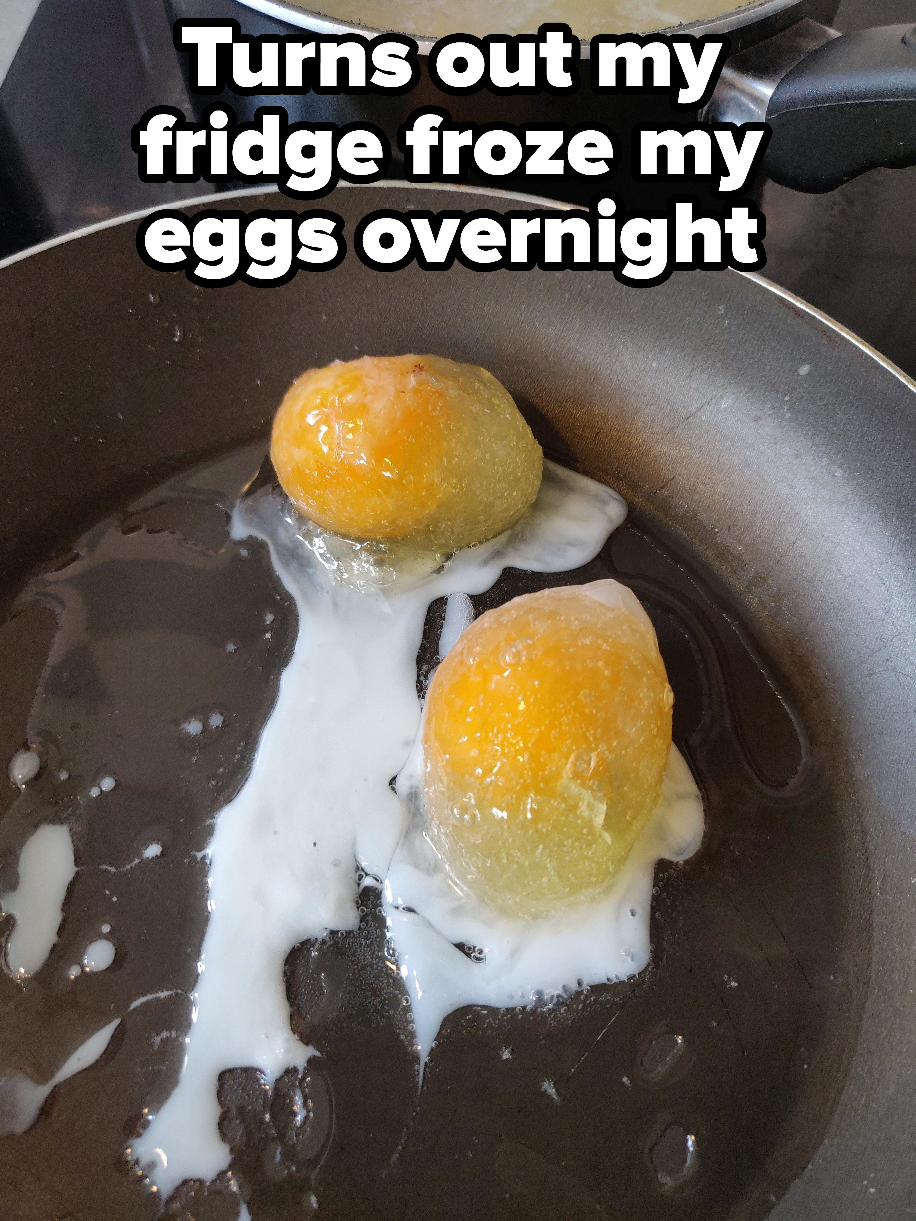Eggs still frozen in a frying pan
