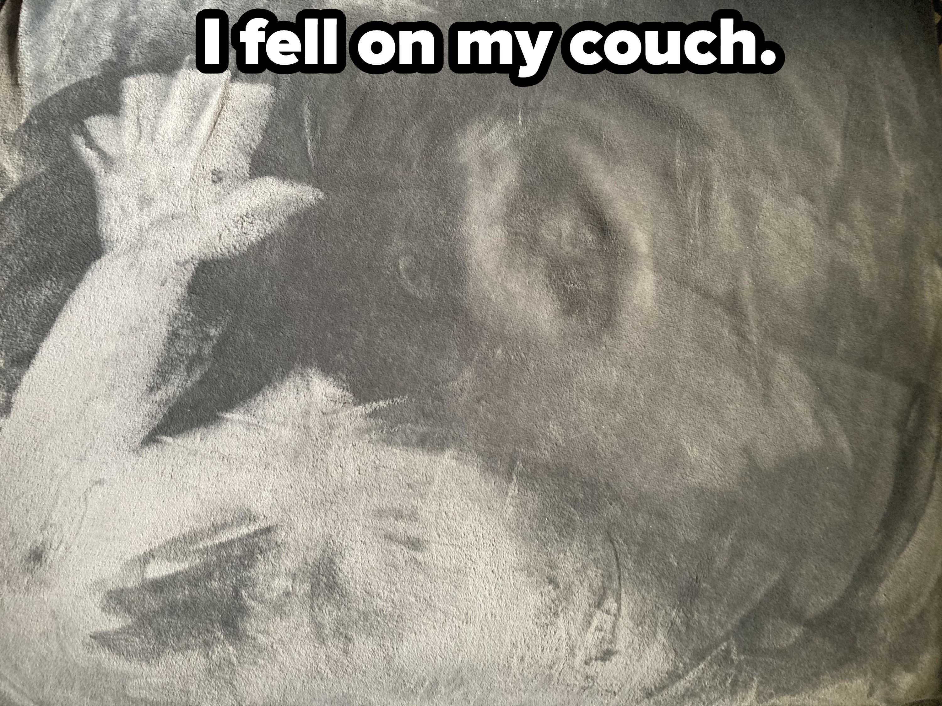 A person&#x27;s hand and face imprinted on a couch