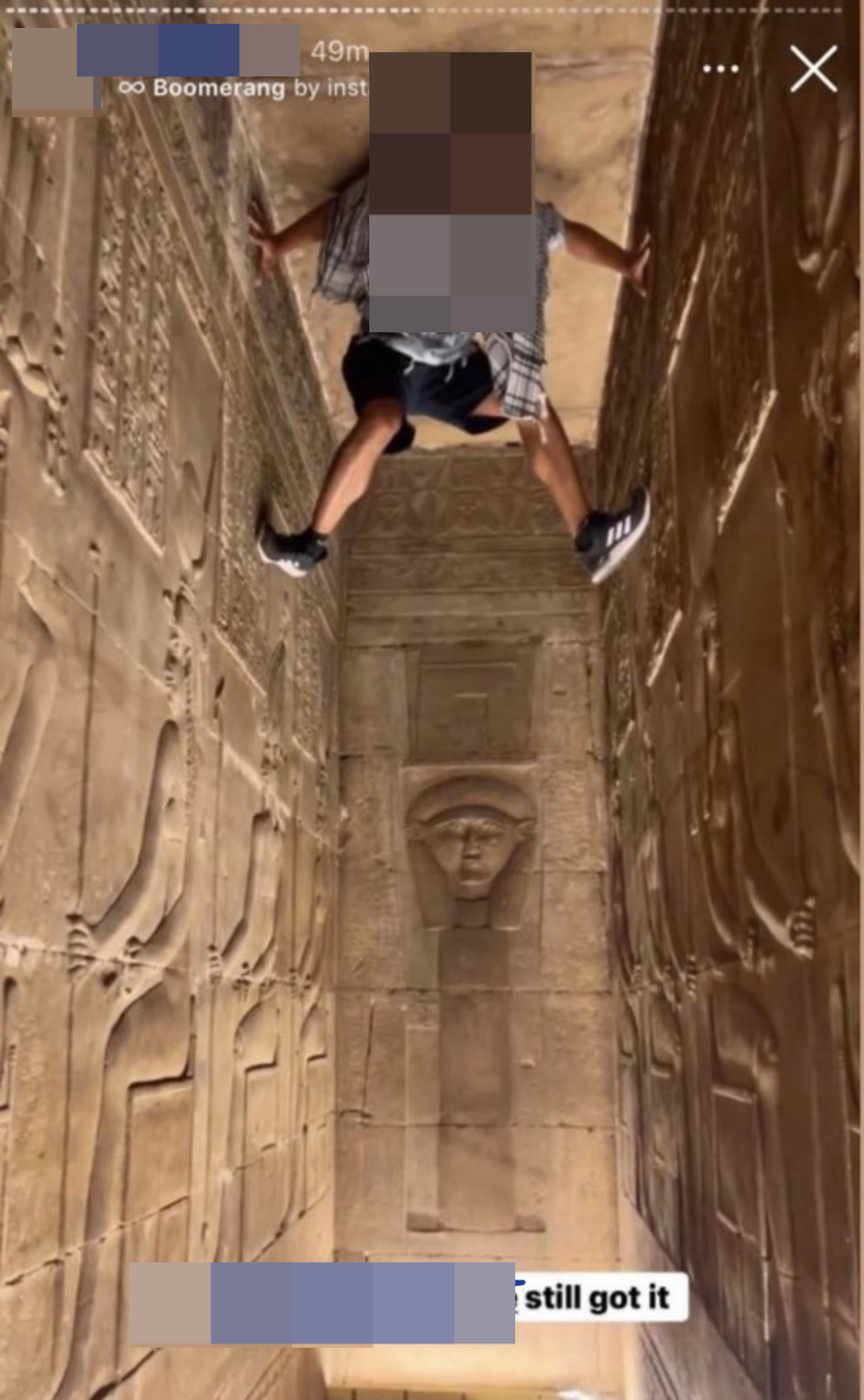 A person climbing ancient Egyptian tombs