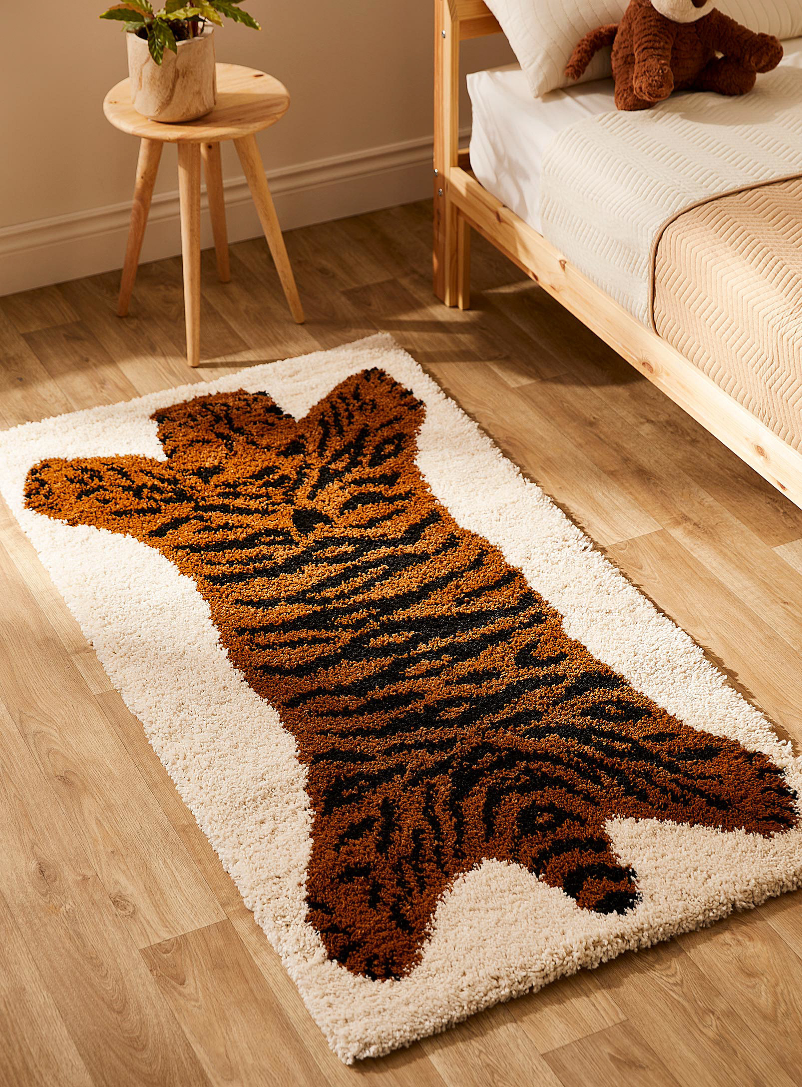 A tiger rug beside a bed