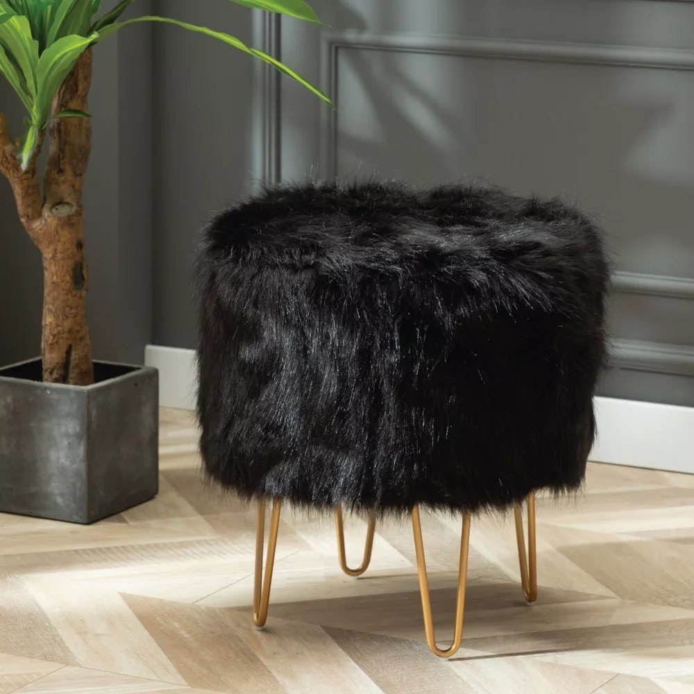 A black faux fur ottoman