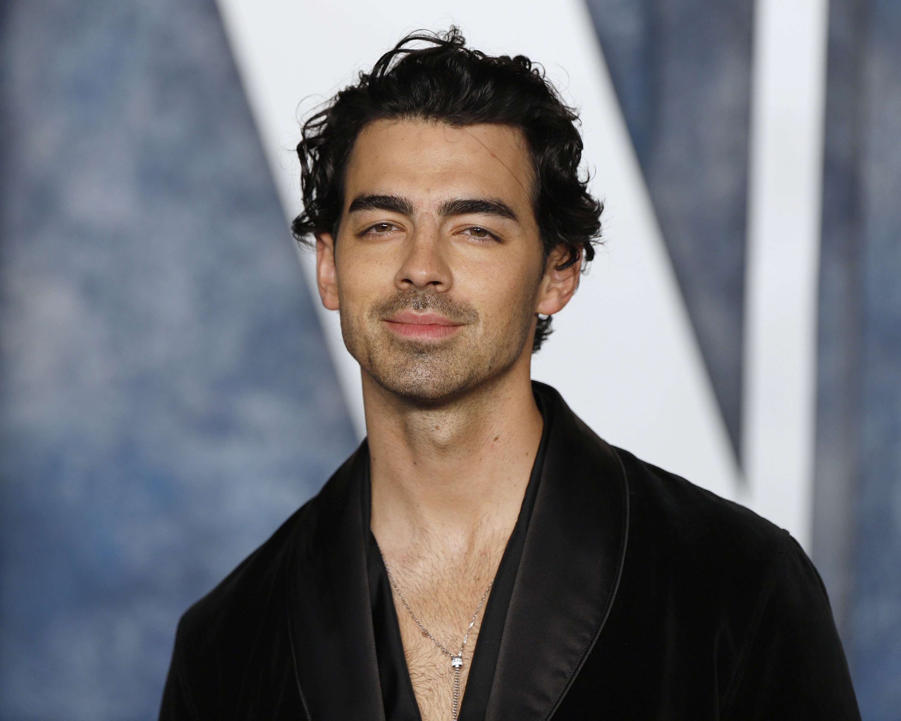 Joe Jonas posing on a red carpet