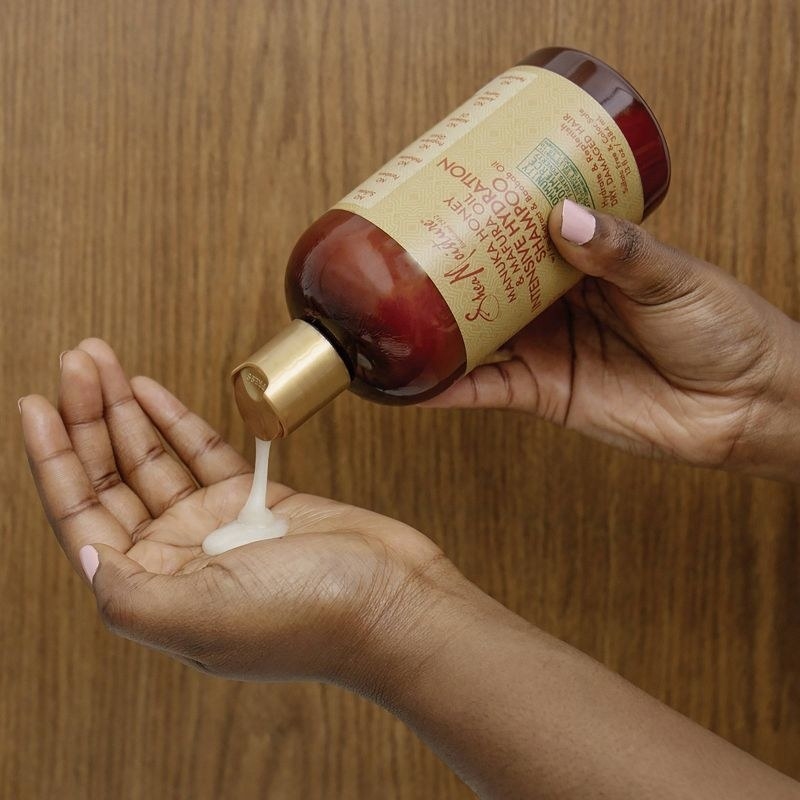 A person pouring out shampoo into their hand