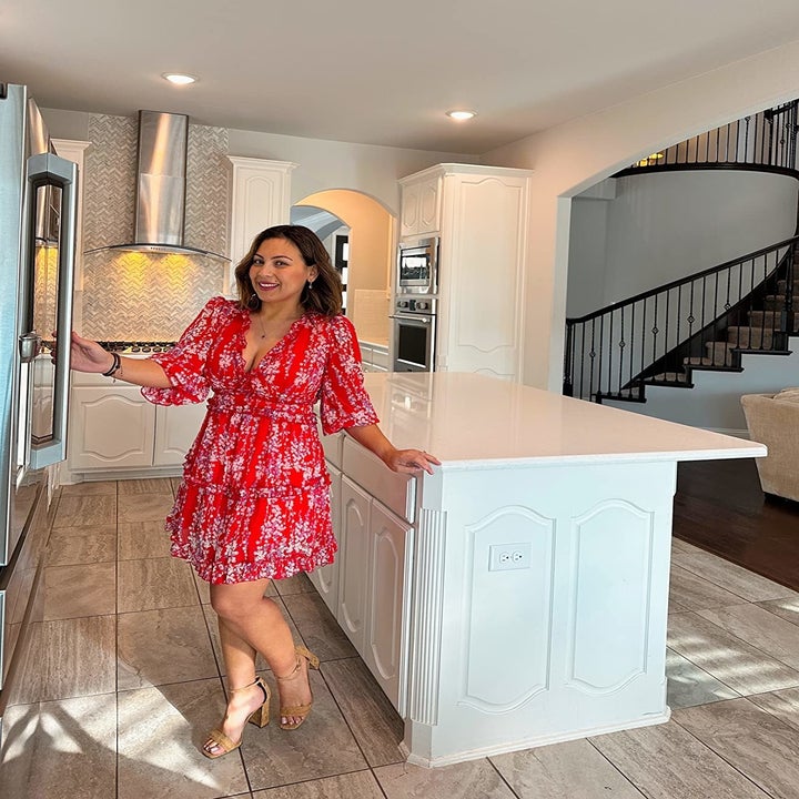 Reviewer wearing the dress in red with brown sandals