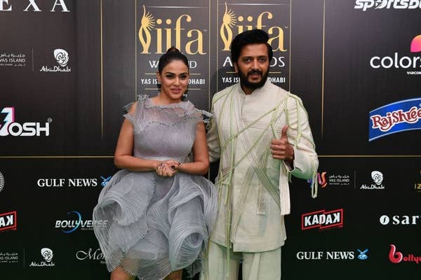Bollywood actor Ritesh Deshmukh (R) and actress Genelia D'Souza arrive for the green carpet ahead of 22nd edition of the International Indian Film Academy (IIFA) Awards