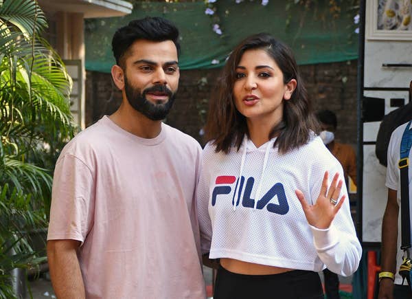 Indian cricketer Virat Kohli along with his actress wife Anushka Sharma pose for a photo at a studio in Mumbai