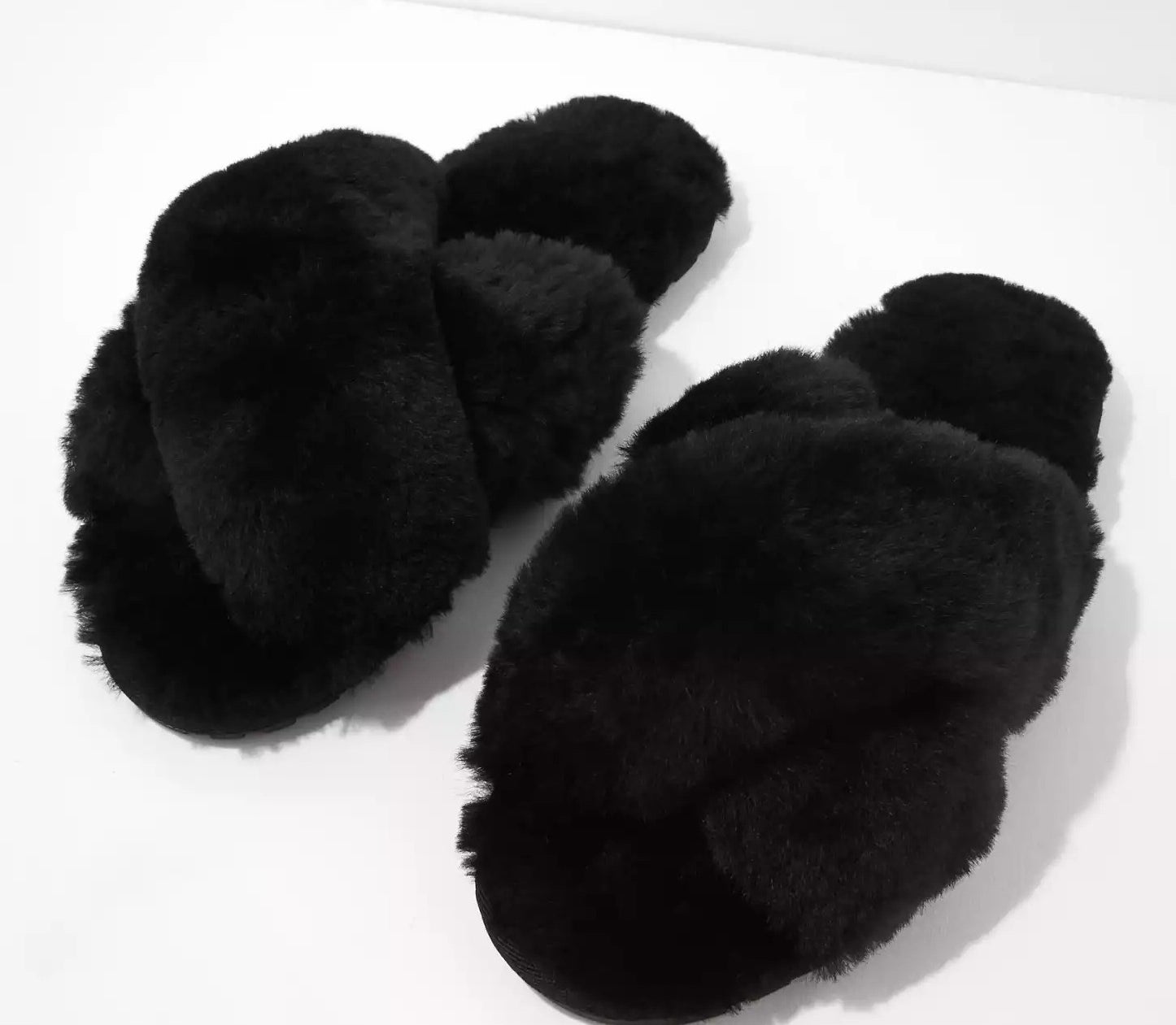 the pair of fuzzy black slippers