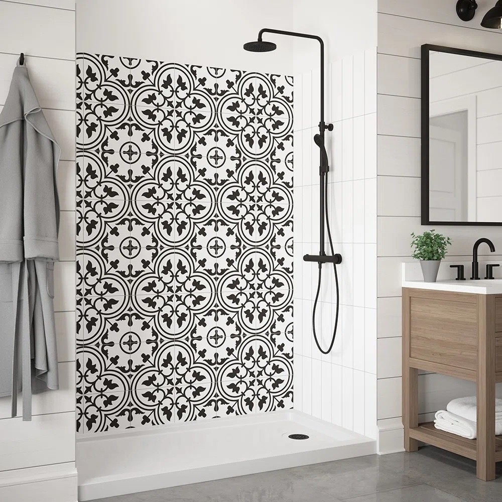 a black and white shower wall with flowery design