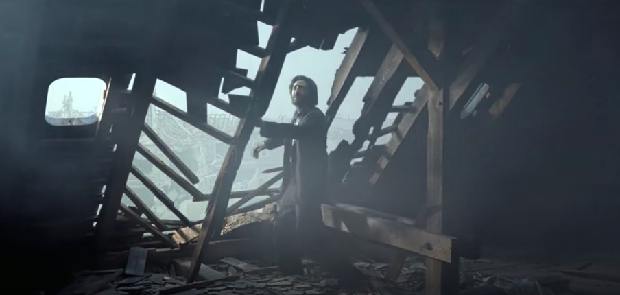 A man stands in the rubble of a room