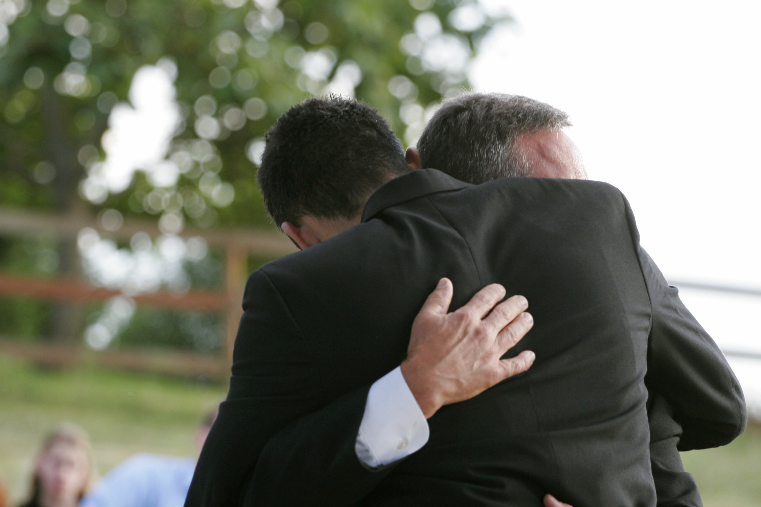 two men hugging at a funeral