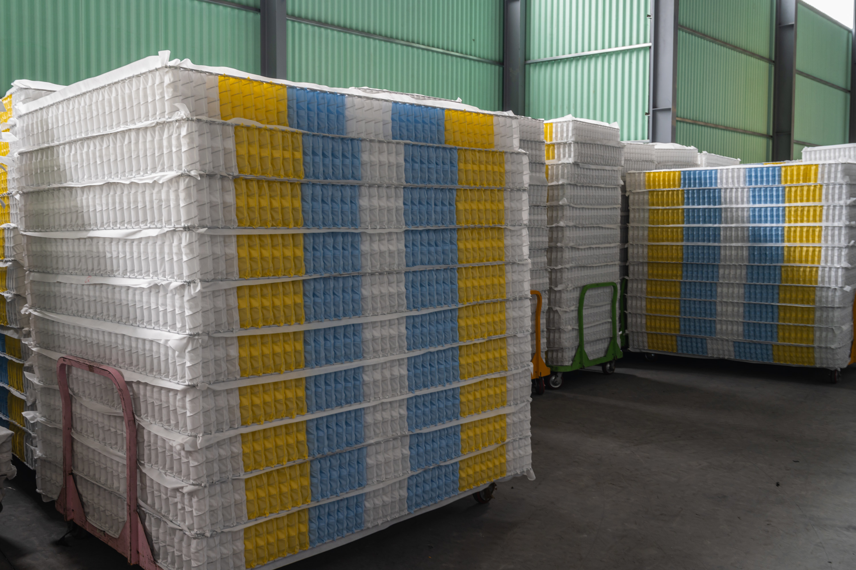 stacked mattresses in production