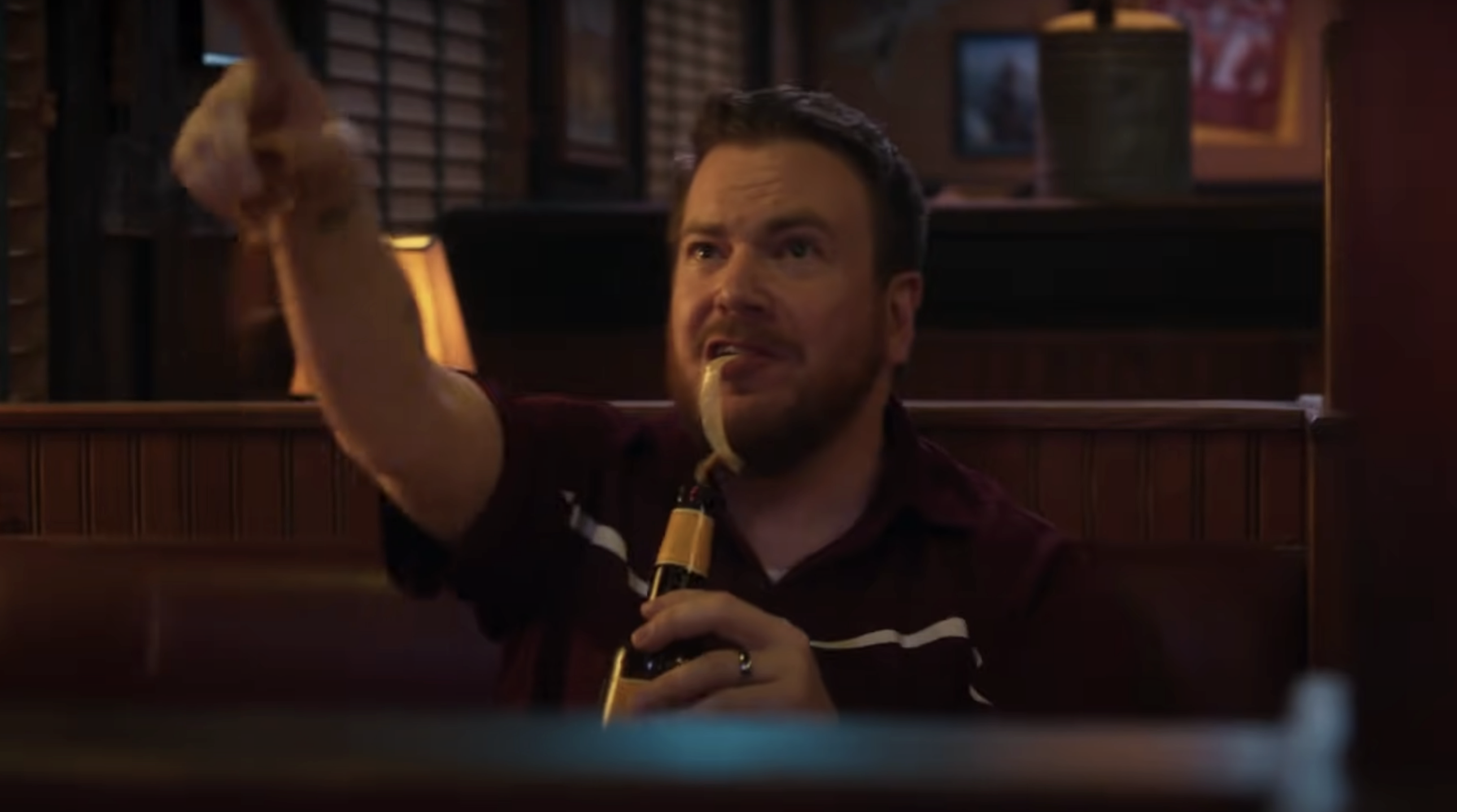 A costumer drinking a beer in a booth in &quot;Support the Girls&quot;