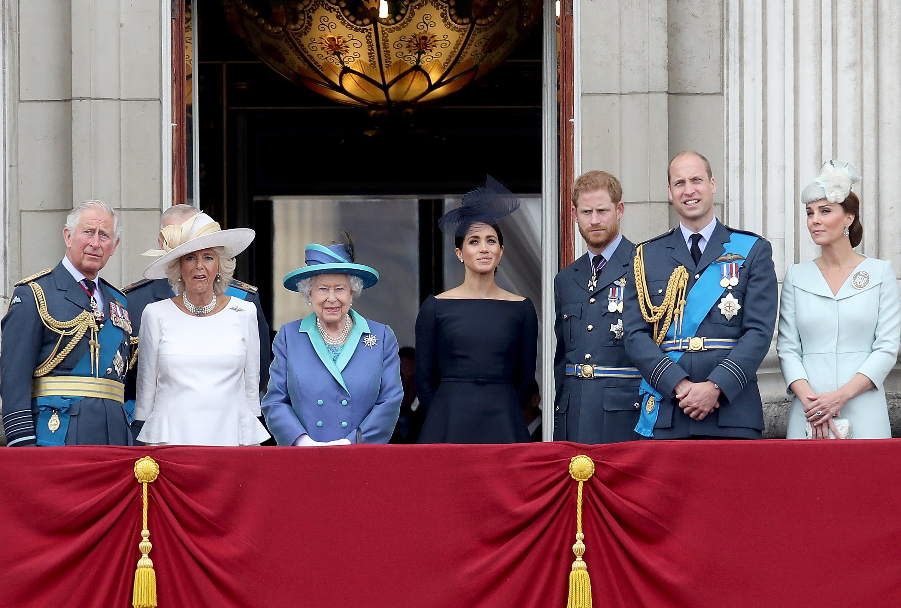 Meghan and Harry pose with the family on a balcony