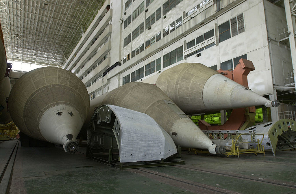 three pointy-noses rockets collect dust in an old warehouse