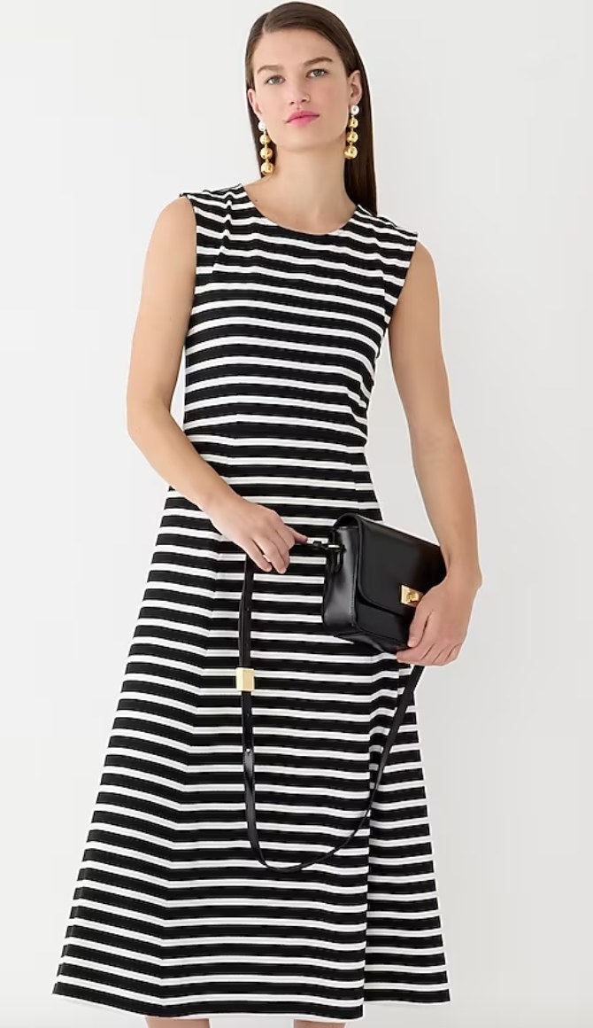 model wearing black and white striped dress with black bag