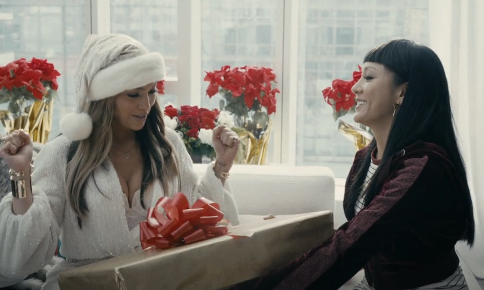 Constance Wu and Jennifer Lopez exchanging Christmas gifts in &quot;Hustlers&quot;