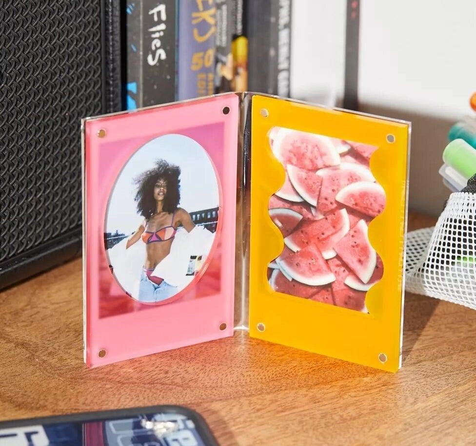 the photo frame with pictures in it on a table