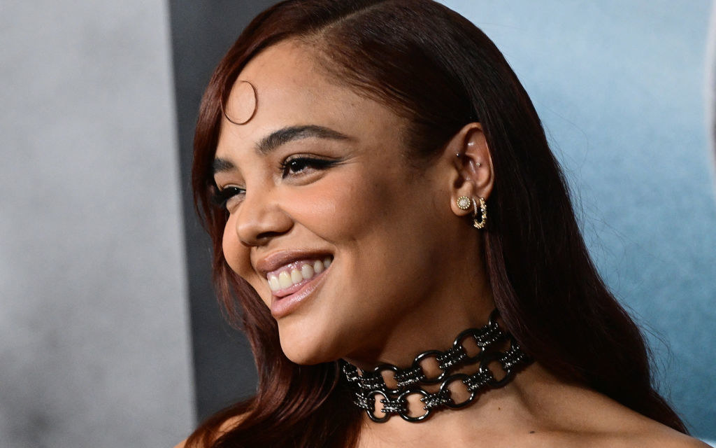 A closeup of Tessa smiling on the red carpet