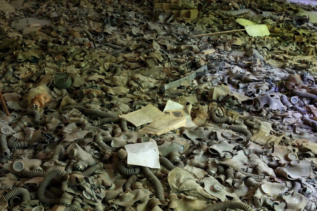 The gas masks are all piled up on top of each other, and it looks like there are hundreds of them