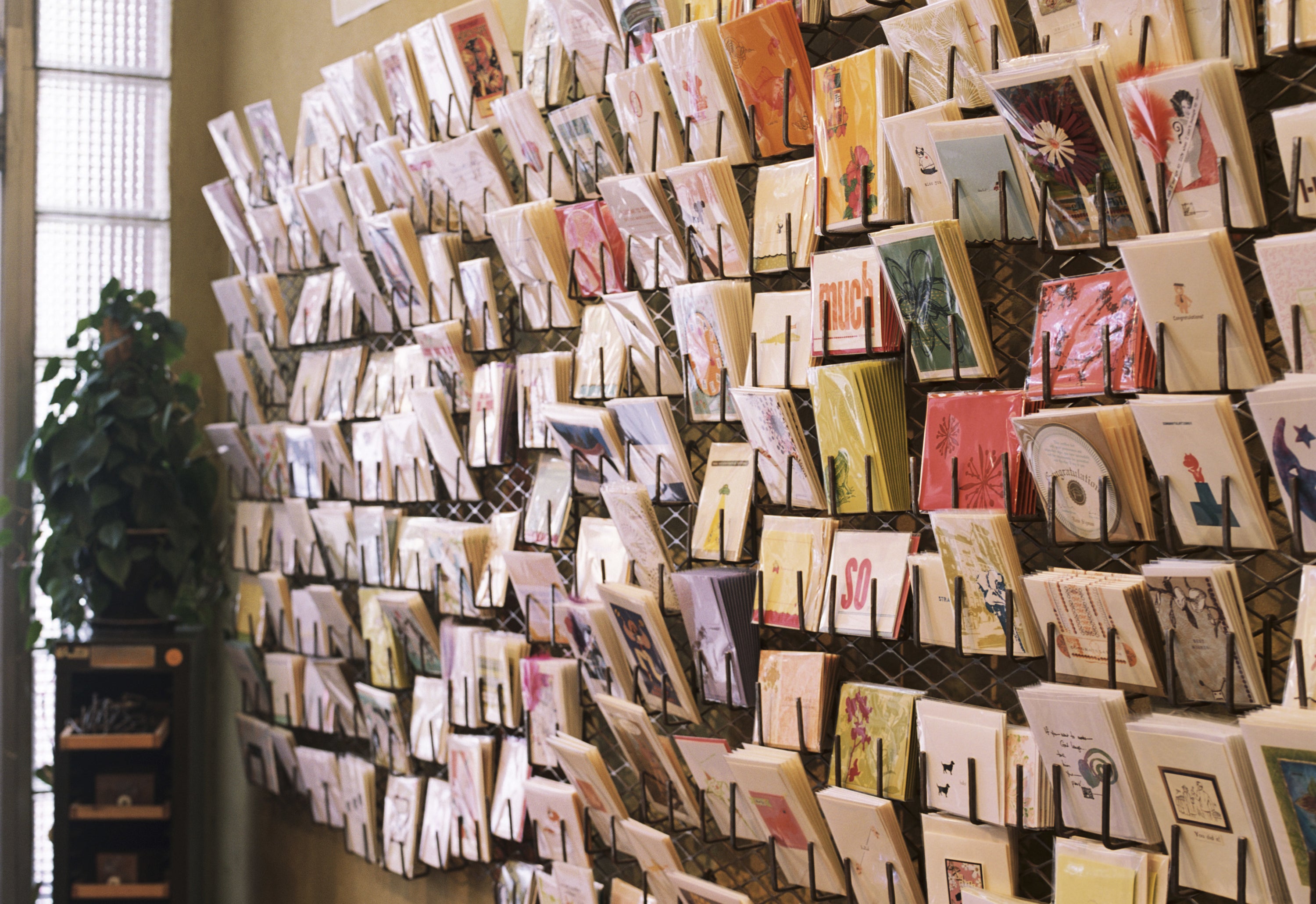 A wall of greeting cards in a store