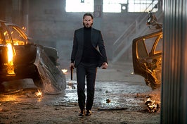 John Wick walks through a warehouse