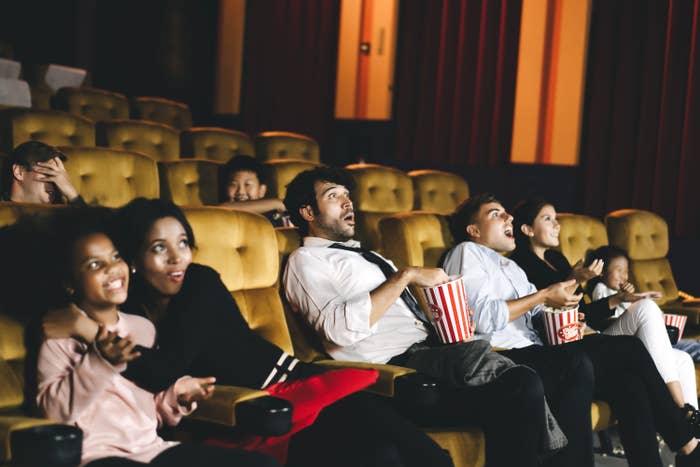 Surprised moviegoers reacting to a film