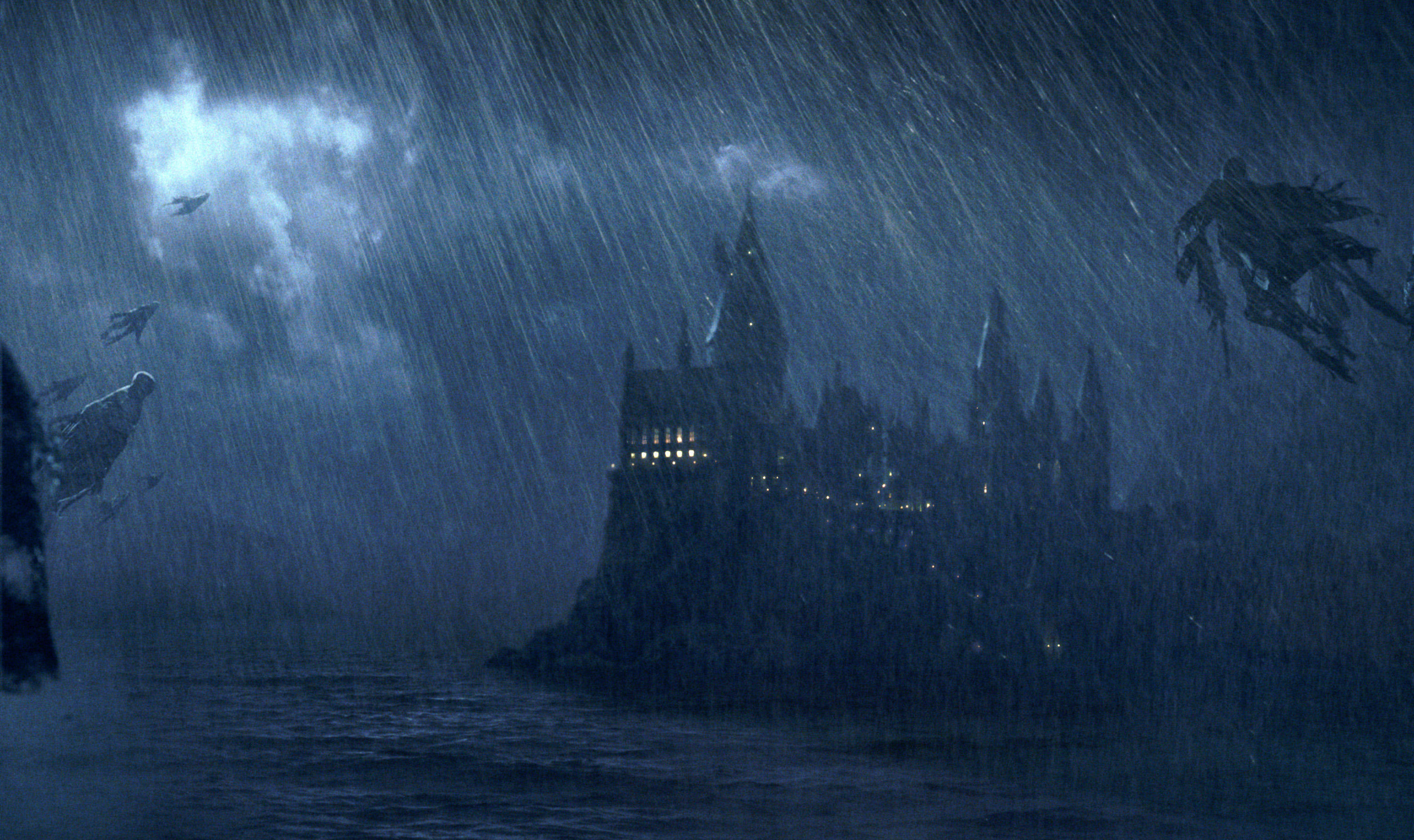 Flying hooded, wraithlike figures descend upon Hogwarts Castle on a rainy evening