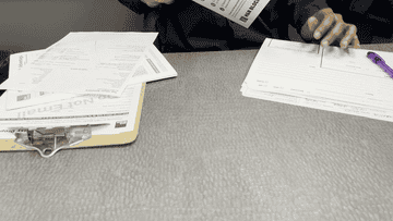 tax expert handing author a folder
