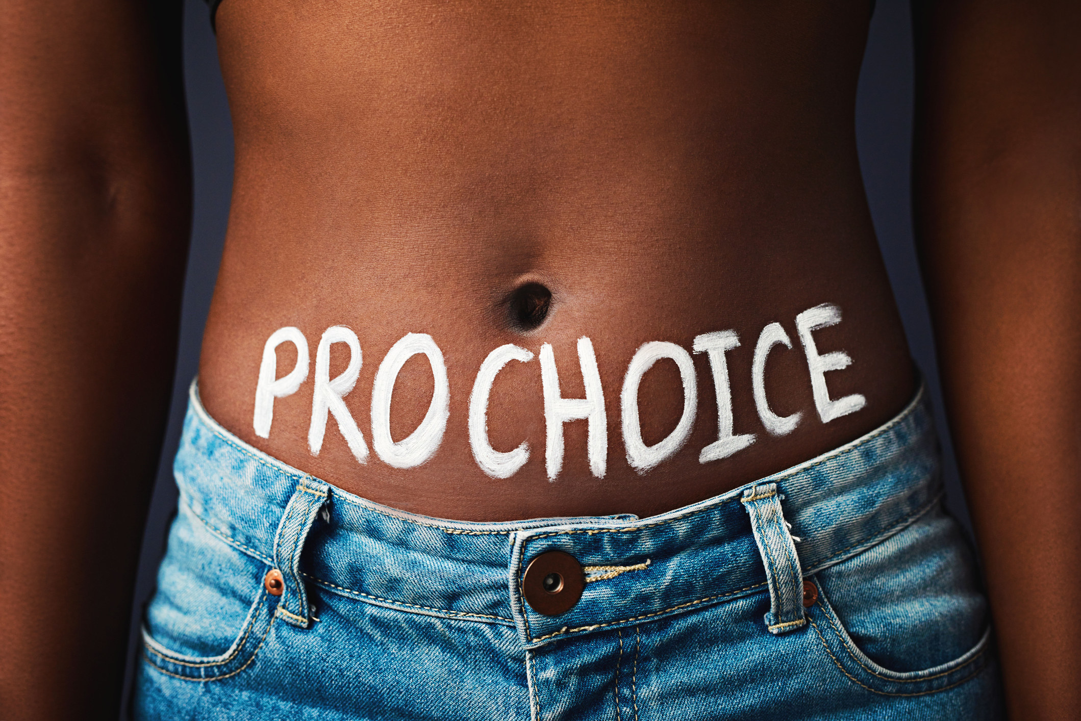 Woman with &quot;PRO CHOICE&quot; painted on her stomach