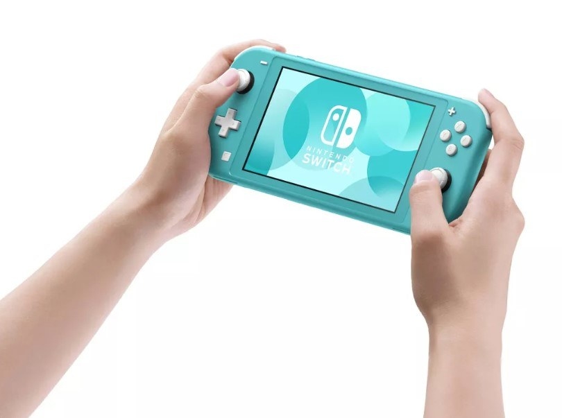 A model using the Switch Lite in the color Turquoise