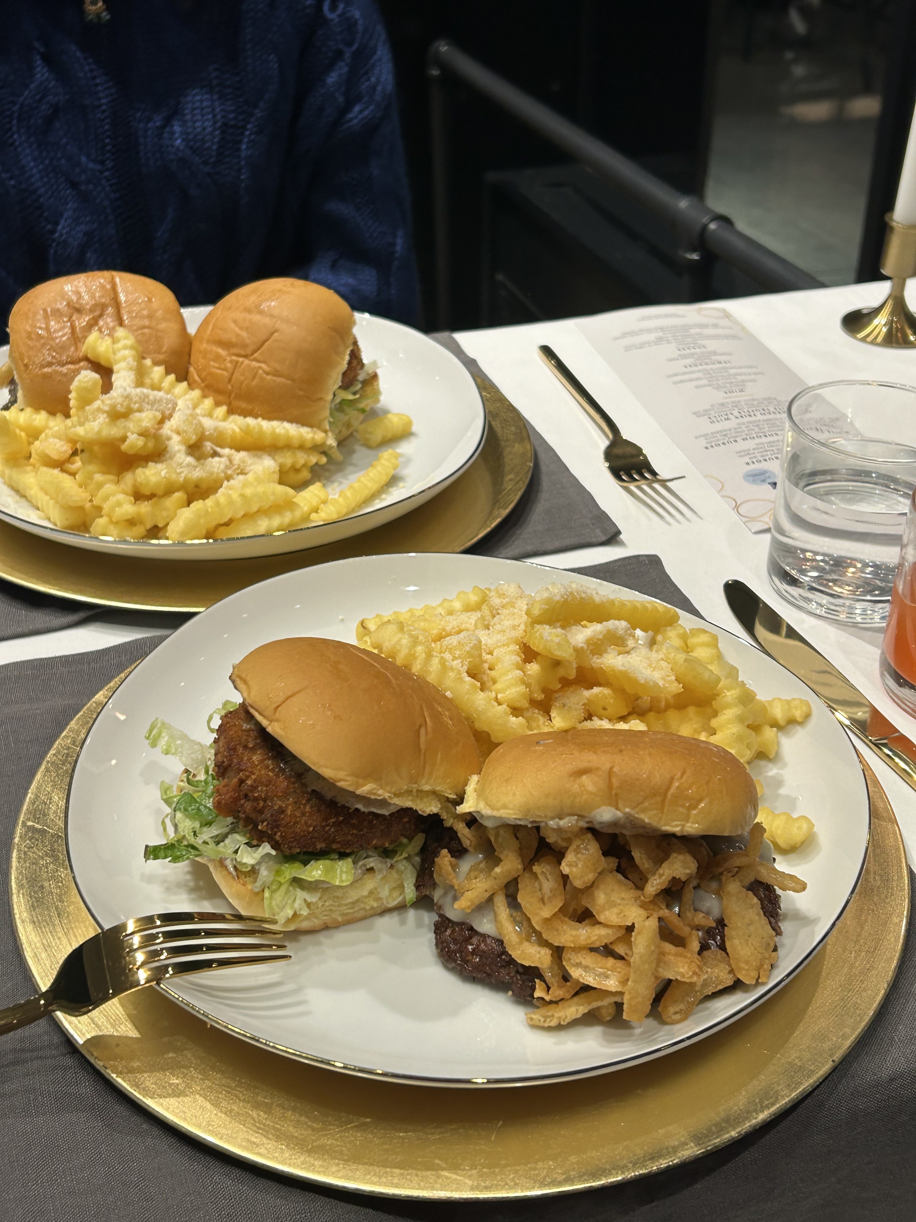 Two plates featuring the White Truffle Burgers and Parmesan Fries