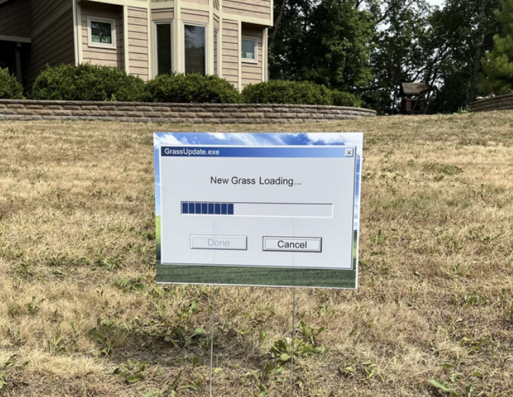 A &quot;New Grass Loading&quot; sign on dry-looking grass with the computer loading bar and &quot;Done&quot; or &quot;Cancel&quot; fields