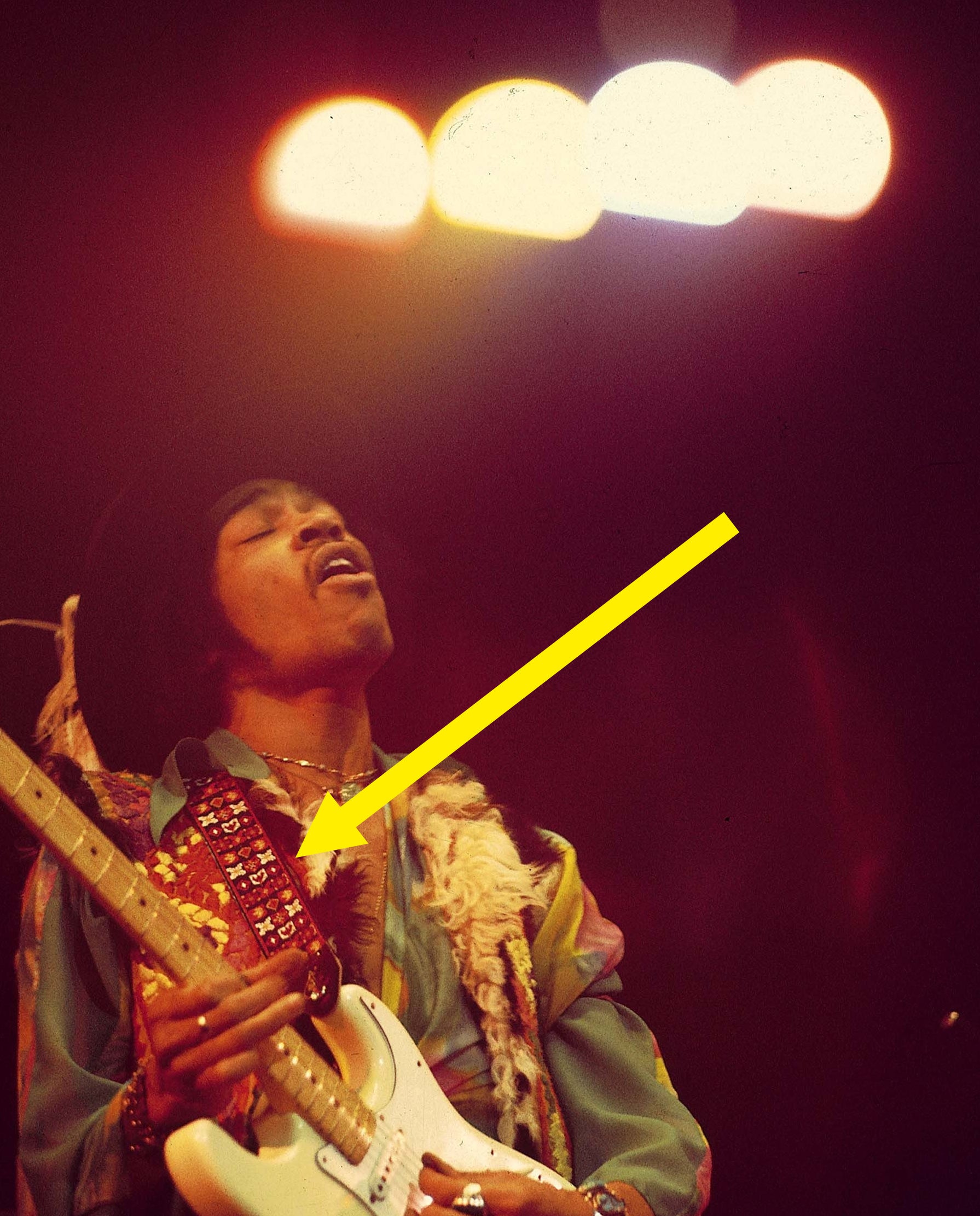 Jimi playing with the guitar strap