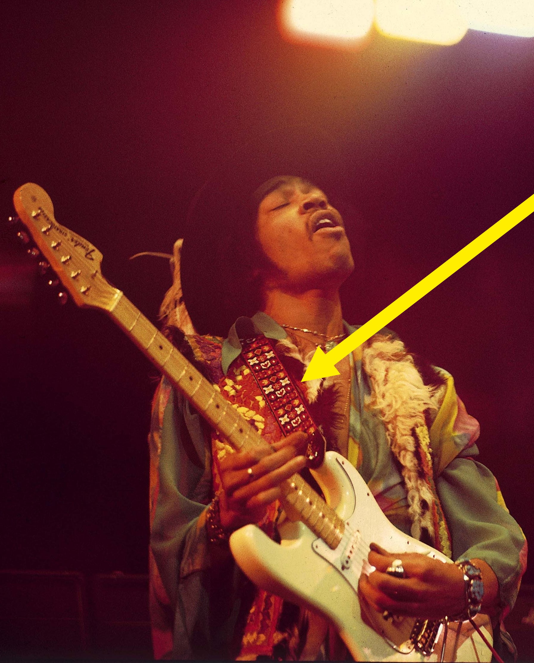 Jimi playing with the guitar strap