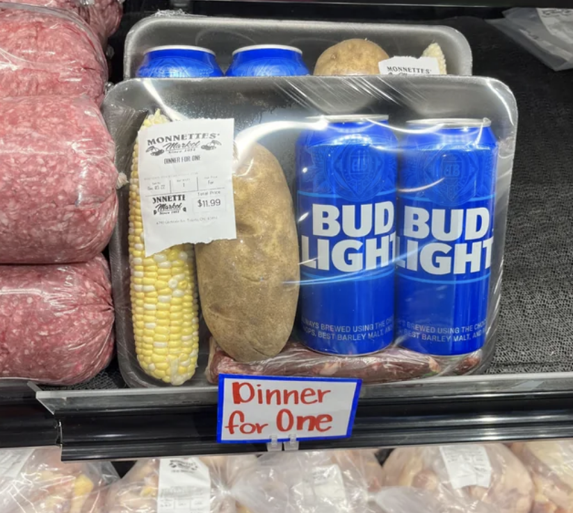 &quot;Dinner for one&quot; with a corn on the cob, a potato, and two Bud Lights