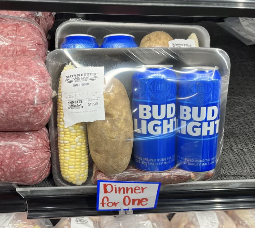 &quot;Dinner for one&quot; with a corn on the cob, a potato, and two Bud Lights
