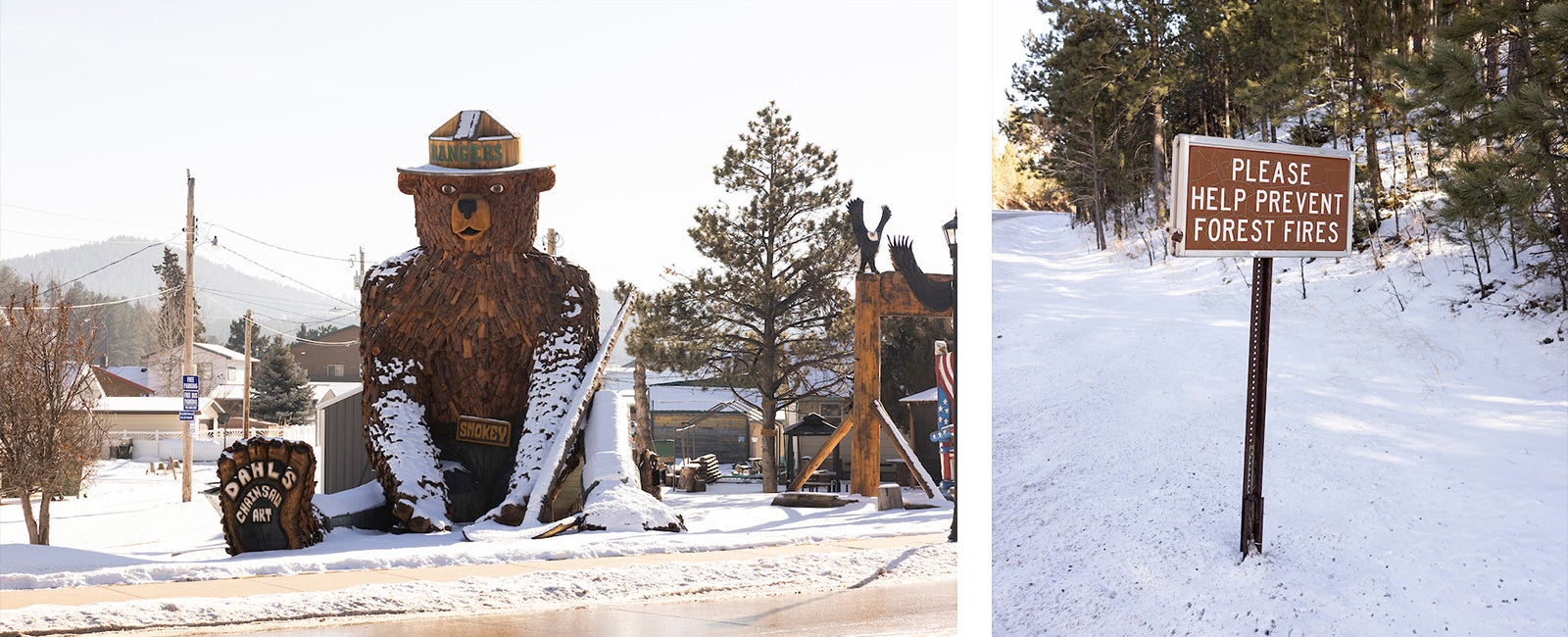 A towering sculpture of Smokey The Bear sitting in the snow and created from scraps of wood, wearing a wooden hat that says “Rangers” in Hill City, South Dakota next to a sign that says “Please help prevent forest fires”