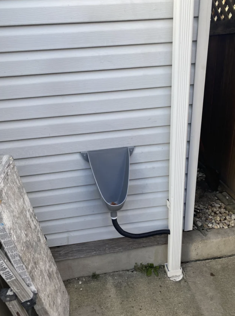 A urinal attached to the side of a house