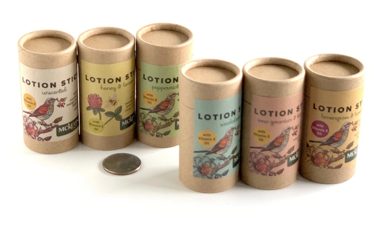 Six of the lotion sticks posed with a quarter for scale