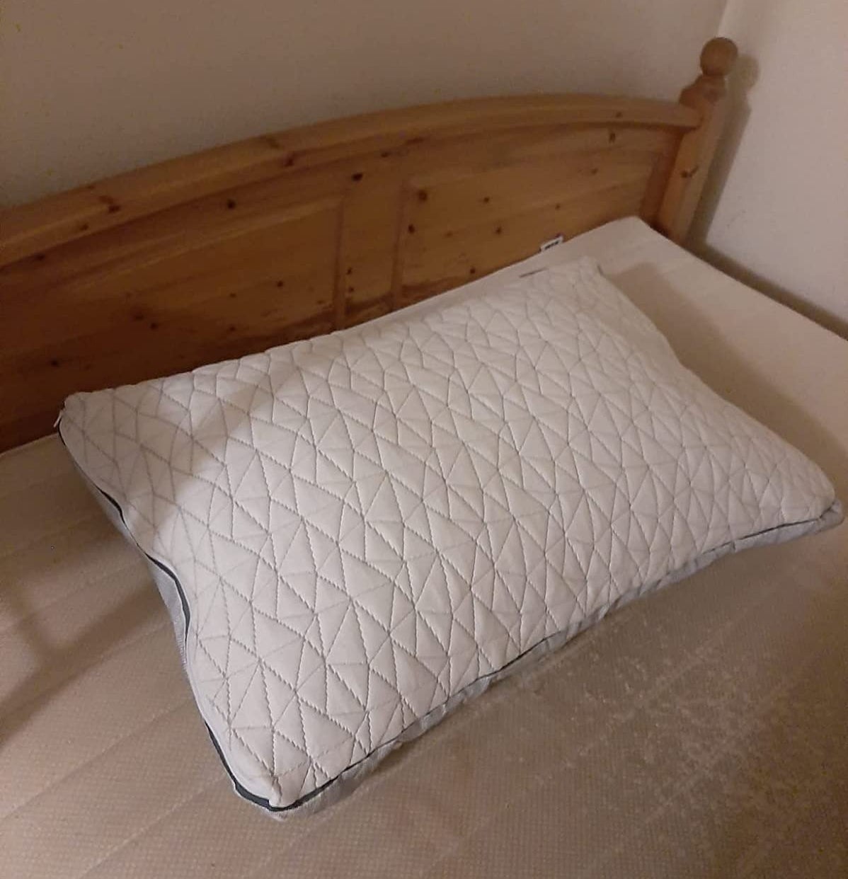 the white memory foam pillow on a bed